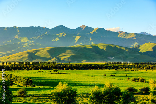 Nalati grassland with beautiful mountain natural landscape in Xinjiang at sunset,China. © ABCDstock