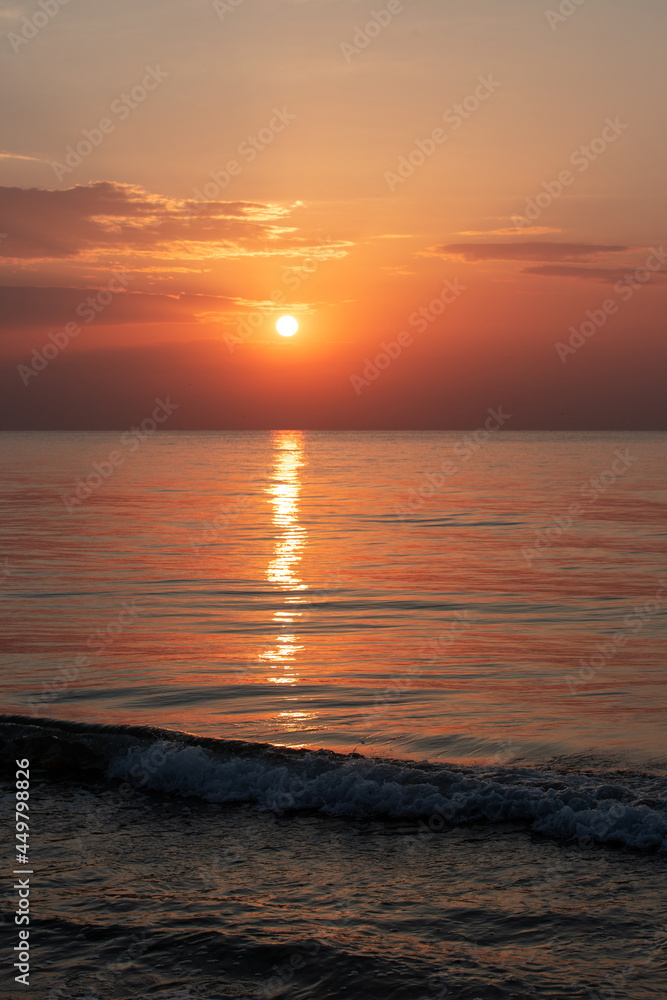 The sun reflecting in the sea water after sunrise The sun reflecting in the sea water after sunrise