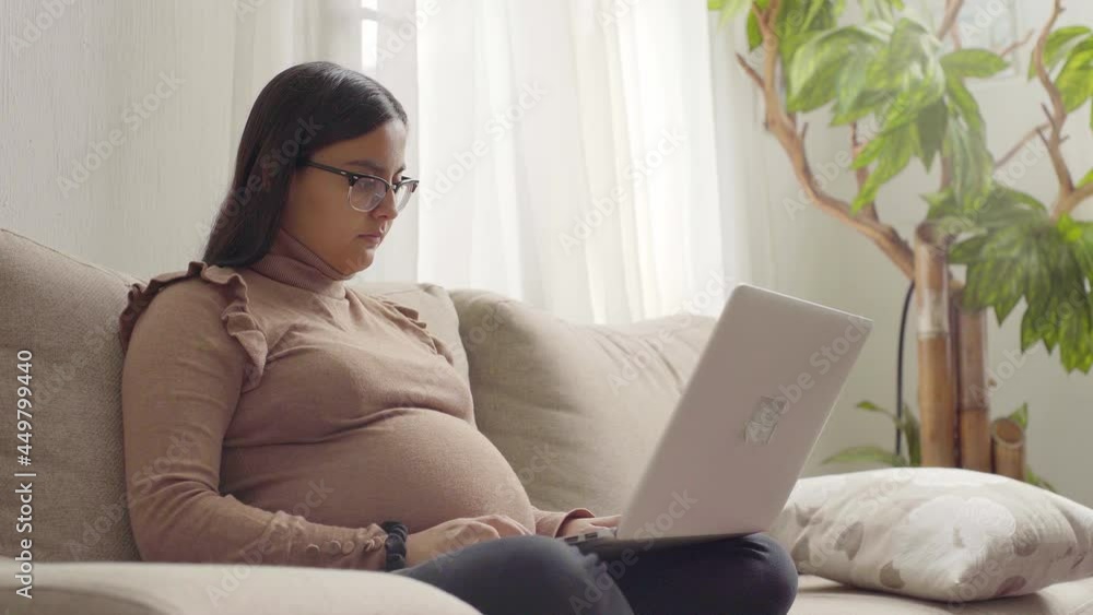 4k a young pregnant latinx woman working on laptop 4k a young pregnant latinx woman working on laptop