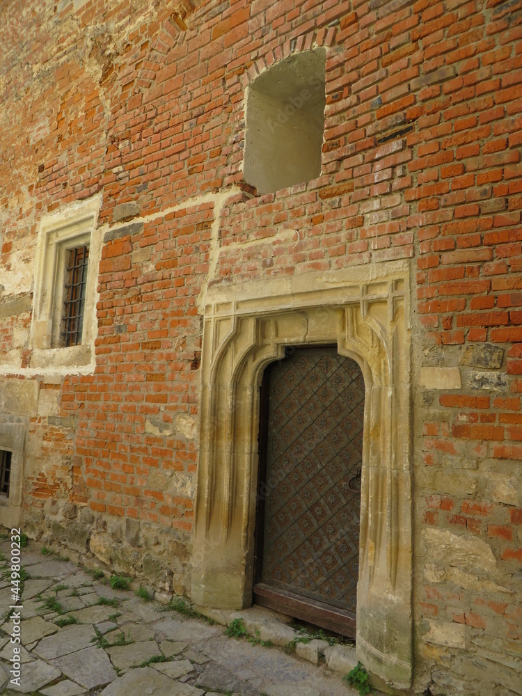 old windows and doors on a brick wall, the atmosphere of the castle
