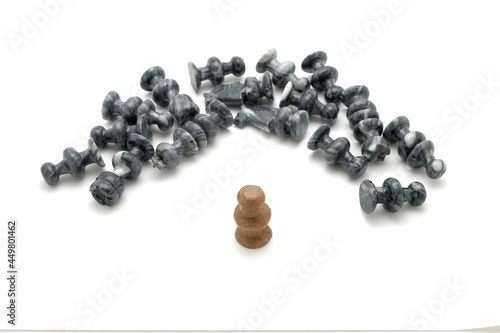 Chess pieces, defeated black pieces laying down with standing white piece