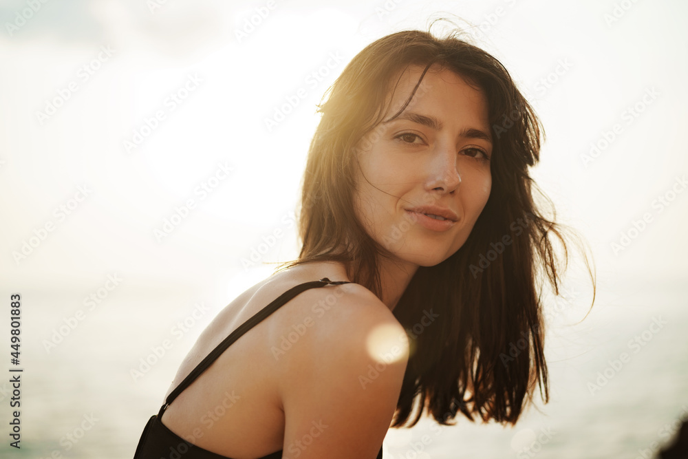 Young smiling woman outdoors portrait at beach Young smiling woman outdoors portrait at beach