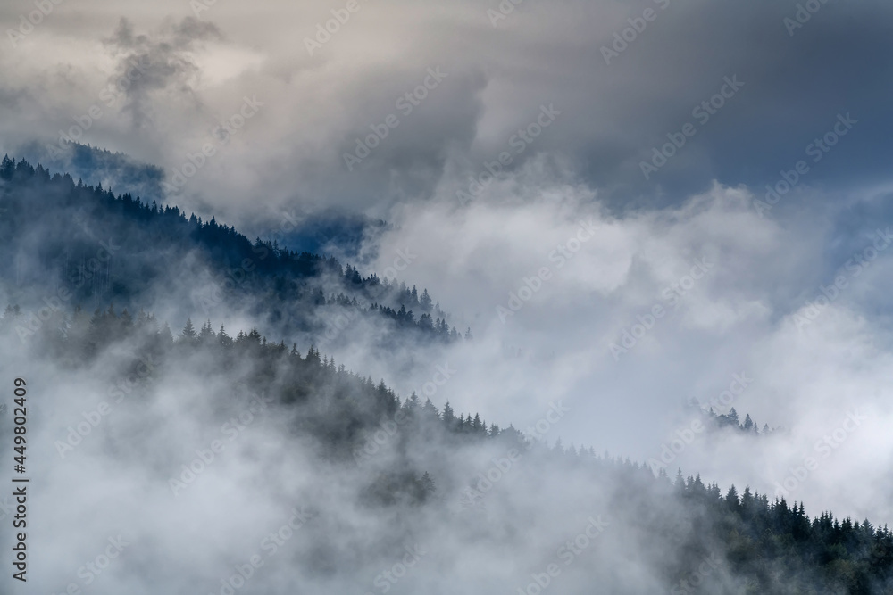 Majestic view on beautiful fog and cloud mountains in mist landscape