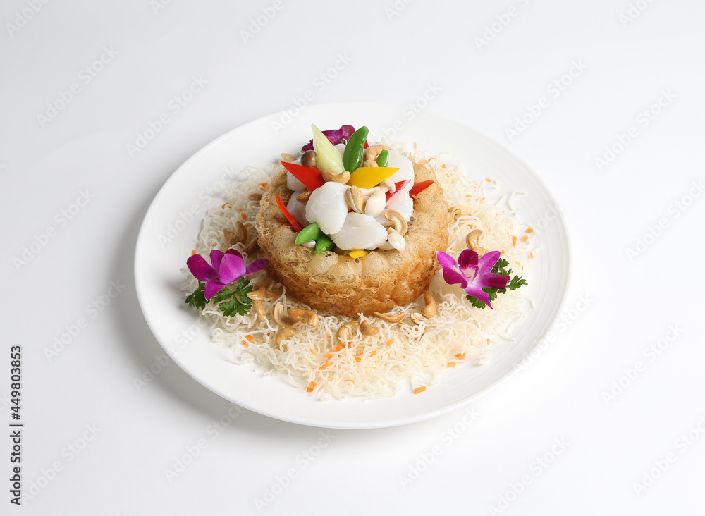 deep fried crispy taro yam ring with stir fried scallop and vegetables in white background asian halal menu deep fried crispy taro yam ring with stir fried scallop and vegetables in white background asian halal menu