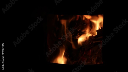 cosy winter outdoor firepit with beautiful flames burning wood and cardboard, photo