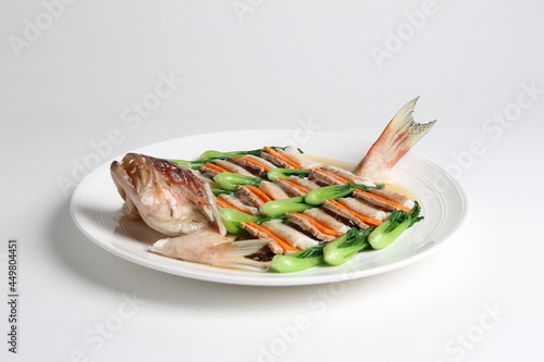 steamed whole fish grouper seafood fillet in 2 way style and vegetable in white background asian halal menu