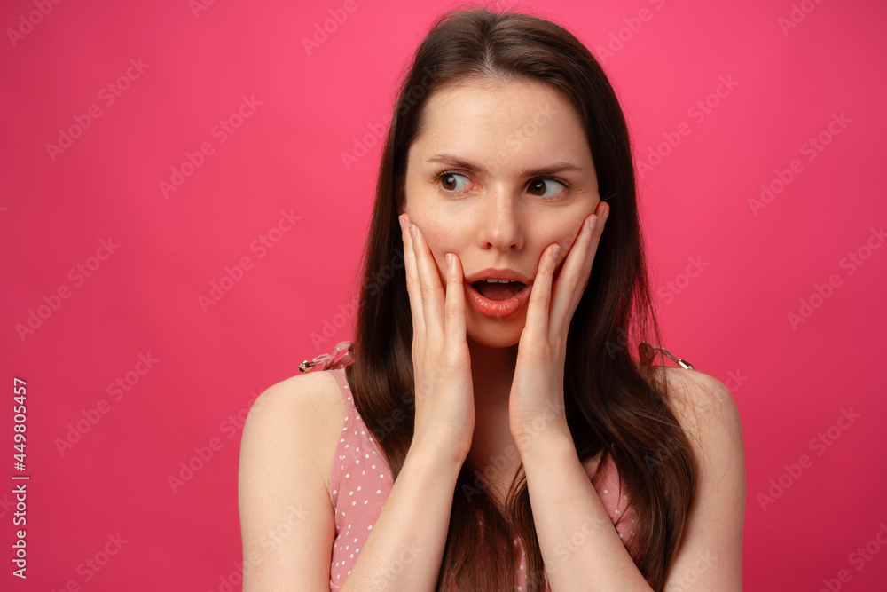 Shocked and surprised girl screaming against pink background Shocked and surprised girl screaming against pink background