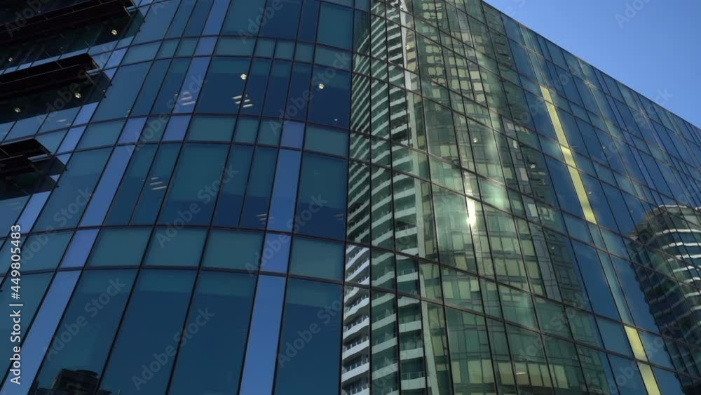 Glass office building with sun and other skyscraper reflection in downtown Melbourne Glass office building with sun and other skyscraper reflection in downtown Melbourne