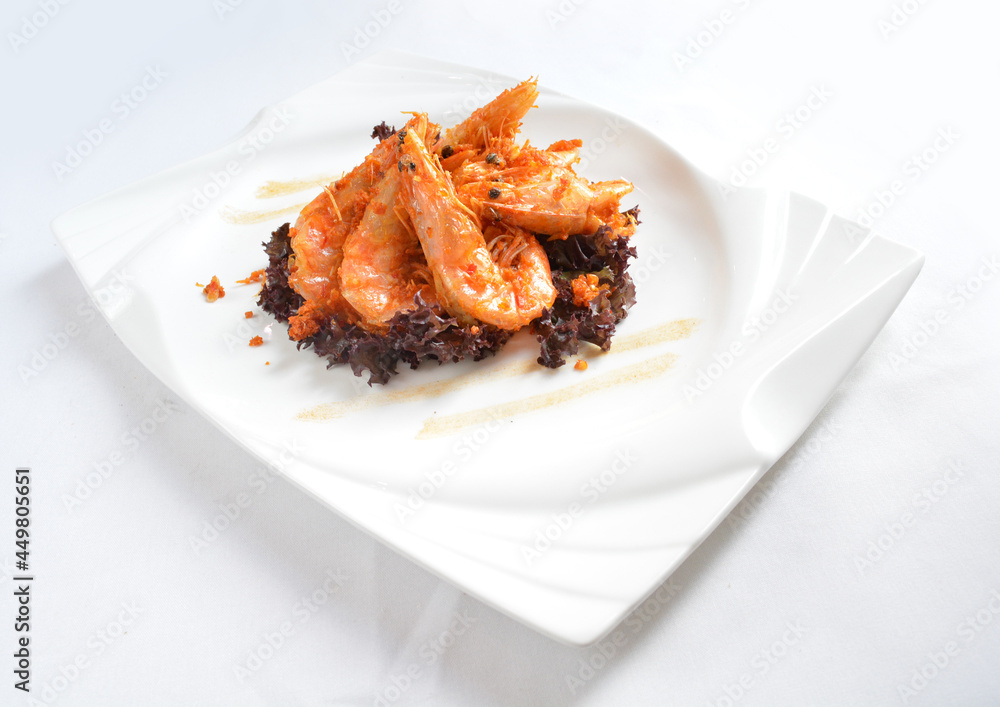 deep fried crispy big fresh tiger prawn in spicy chilli curry sauce in hot clay pot in white background asian halal menu deep fried crispy big fresh tiger prawn in spicy chilli curry sauce in hot clay pot in white background asian halal menu
