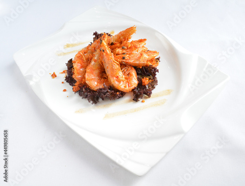 deep fried crispy big fresh tiger prawn in spicy chilli curry sauce in hot clay pot in white background asian halal menu