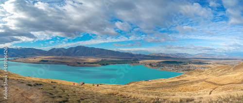 aerial view of a turquoise Lake Tekapo and a lovely Tekapo Town in Autumn, view from Mount John in Mackenzie Region, south island of New Zealand