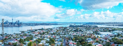 stunning skyline view of Auckland cityscape with Auckland Harbour bridge at the far end, photo taken from Mount Vitoria lookout view point located in seaside village of Devonport © Sthapana S.
