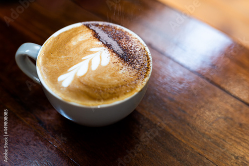 Making a beautiful coffee, with chocolate on the top, in a café in Australia. photo