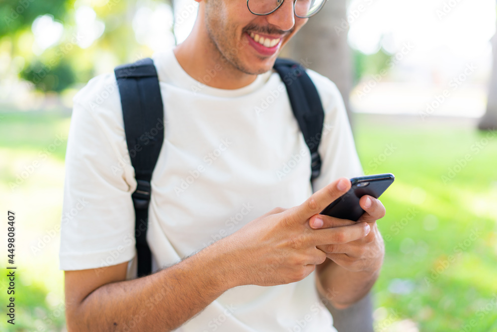 Young student man at outdoors using mobile phone Young student man at outdoors using mobile phone