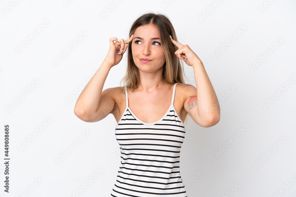 Fototapeta premium Young Romanian woman isolated on white background having doubts and thinking