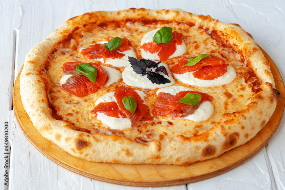 Hot pizza Margherita on white wooden table