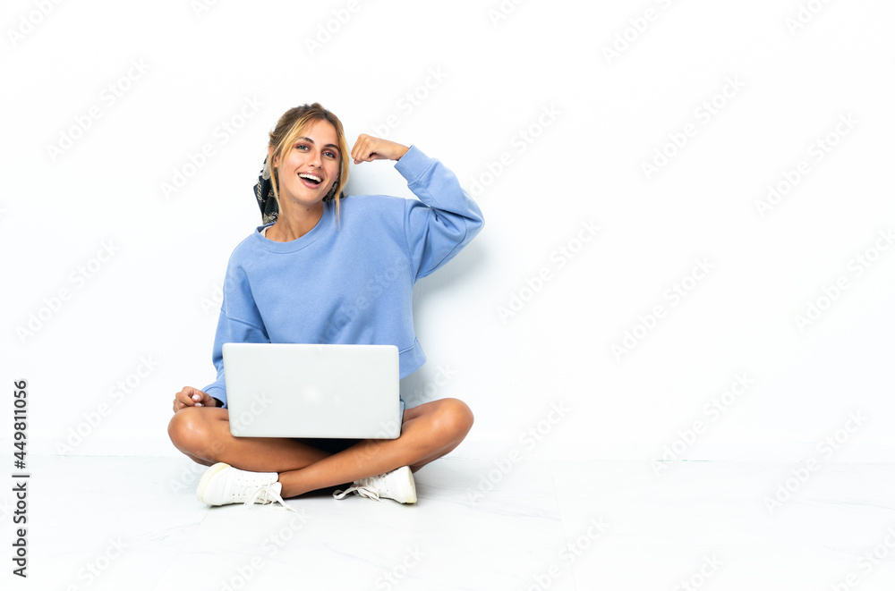 Young blonde Uruguayan girl with the laptop isolated on white background doing strong gesture Young blonde Uruguayan girl with the laptop isolated on white background doing strong gesture
