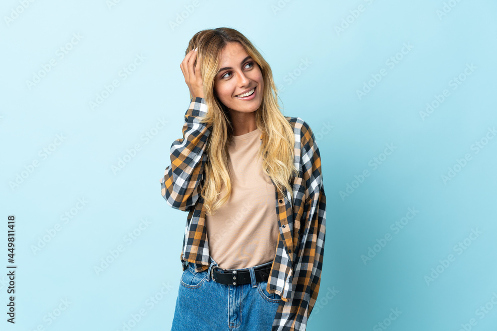 Young blonde Uruguayan isolated on blue background thinking an idea Young blonde Uruguayan isolated on blue background thinking an idea