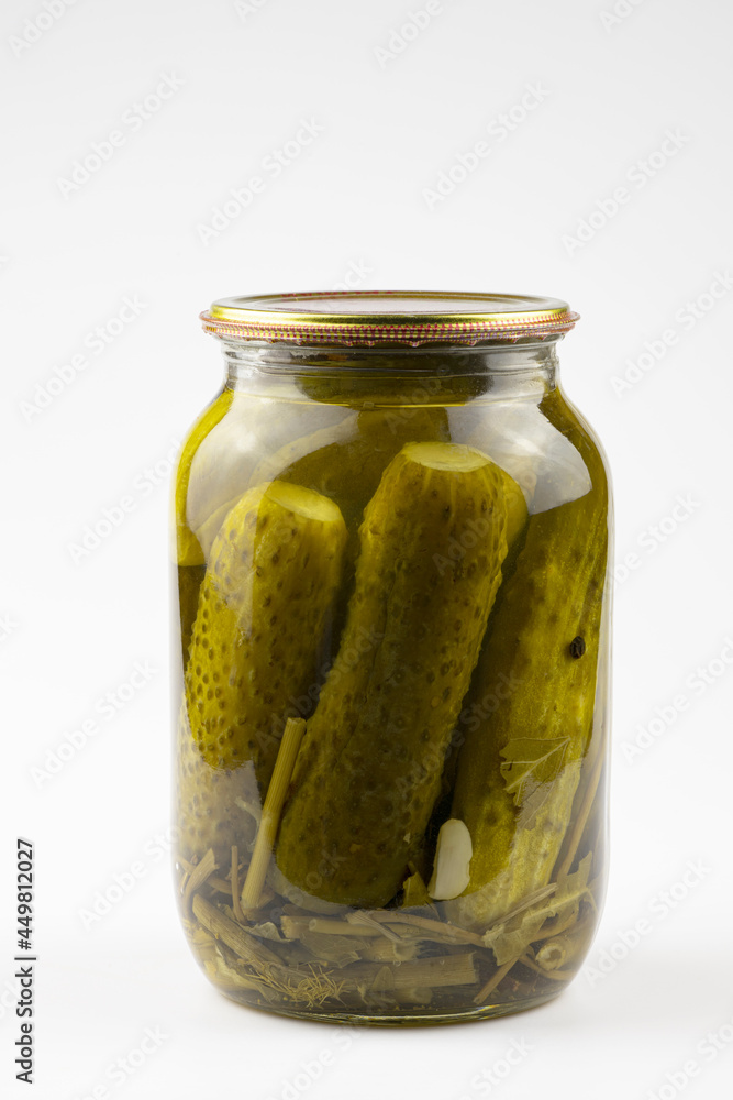Glass jar with canned cucumbers isolated on a white background. Glass jar with canned cucumbers isolated on a white background.