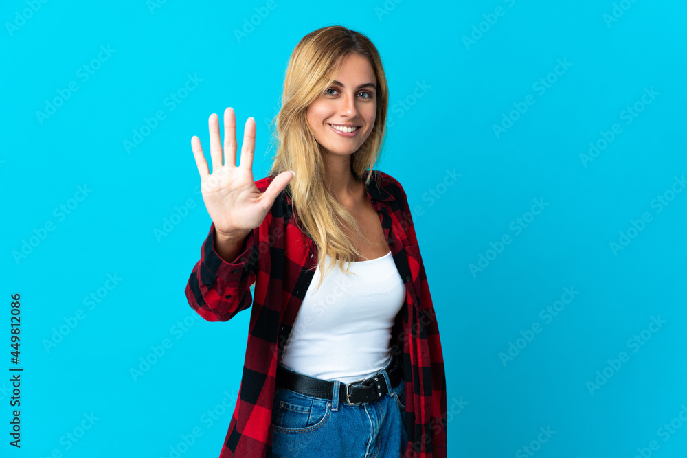 Young blonde Uruguayan woman over isolated background counting five with fingers Young blonde Uruguayan woman over isolated background counting five with fingers