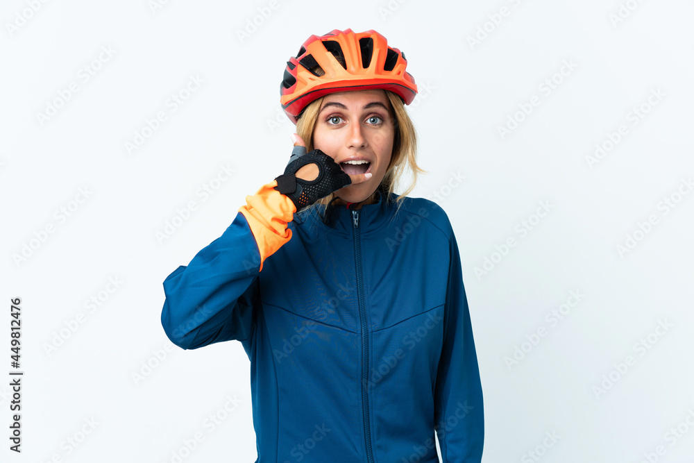 Young blonde Uruguayan cyclist woman isolated on background making phone gesture. Call me back sign Young blonde Uruguayan cyclist woman isolated on background making phone gesture. Call me back sign