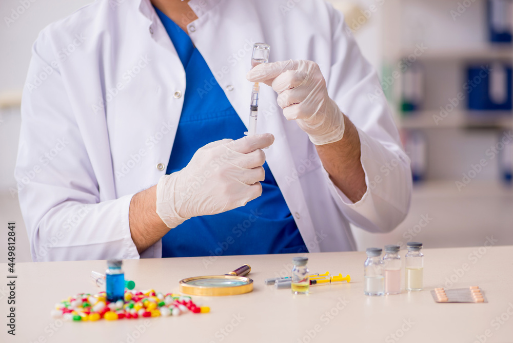 Young male doctor in vaccination concept Young male doctor in vaccination concept