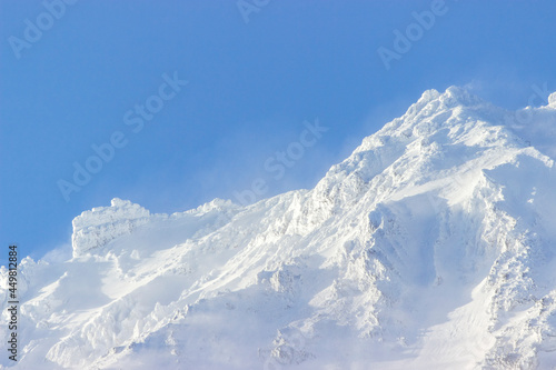 Russia, Natural Park "volcanoes of Kamchatka". The koryaksky volcano covered with snow and clouds on its rocks. The perfect weather for climbing. interesting and affordable for the tourists