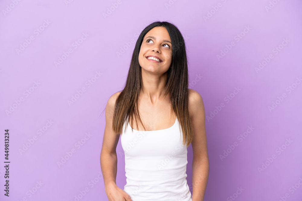 Young caucasian woman isolated on purple background thinking an idea while looking up Young caucasian woman isolated on purple background thinking an idea while looking up