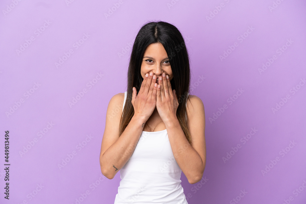 Young caucasian woman isolated on purple background happy and smiling covering mouth with hands Young caucasian woman isolated on purple background happy and smiling covering mouth with hands