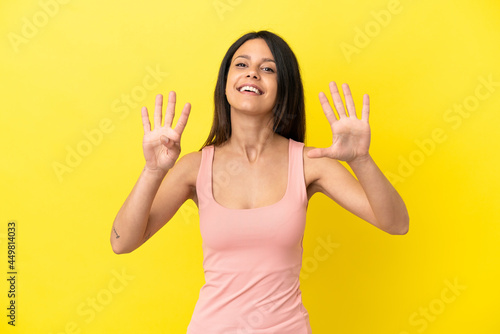 Young caucasian woman isolated on yellow background counting nine with fingers