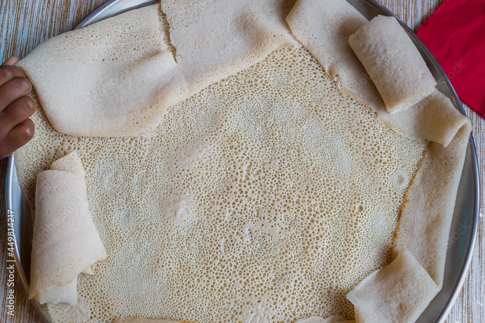 Injera, a fermented flatbread made with teff flour. It is the national ...