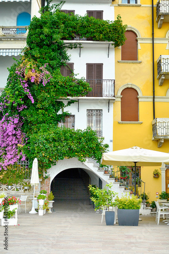 Beautiful yellow house with pink nerium in Rida del Garda, Italy photo