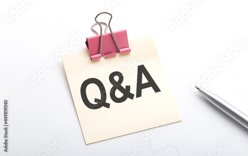 Q and A text on sticker with pen on the white background