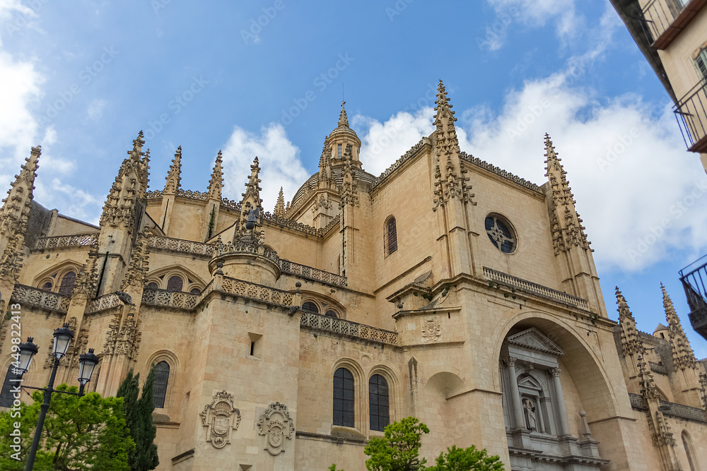 Amazing detailed front facade view at the iconic spanish gothic building at the Segovia cathedral, towers and domes, downtown city