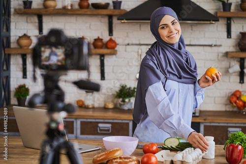 Happy Muslim woman makin a video for her culinary blog