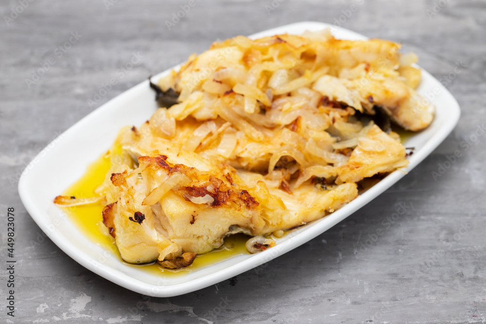 fried cod fish with onion and olive oil on white dish fried cod fish with onion and olive oil on white dish