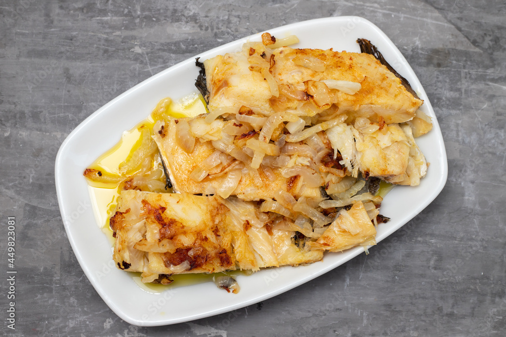 fried cod fish with onion and olive oil on white dish fried cod fish with onion and olive oil on white dish