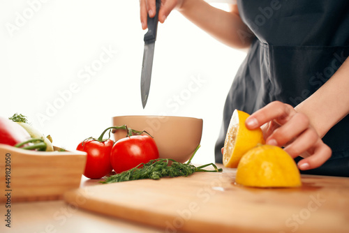 slicing lemon on a cutting board kitchen vegetables cooking