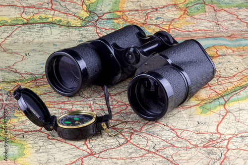 Compass and Binoculars on an Old Route Map