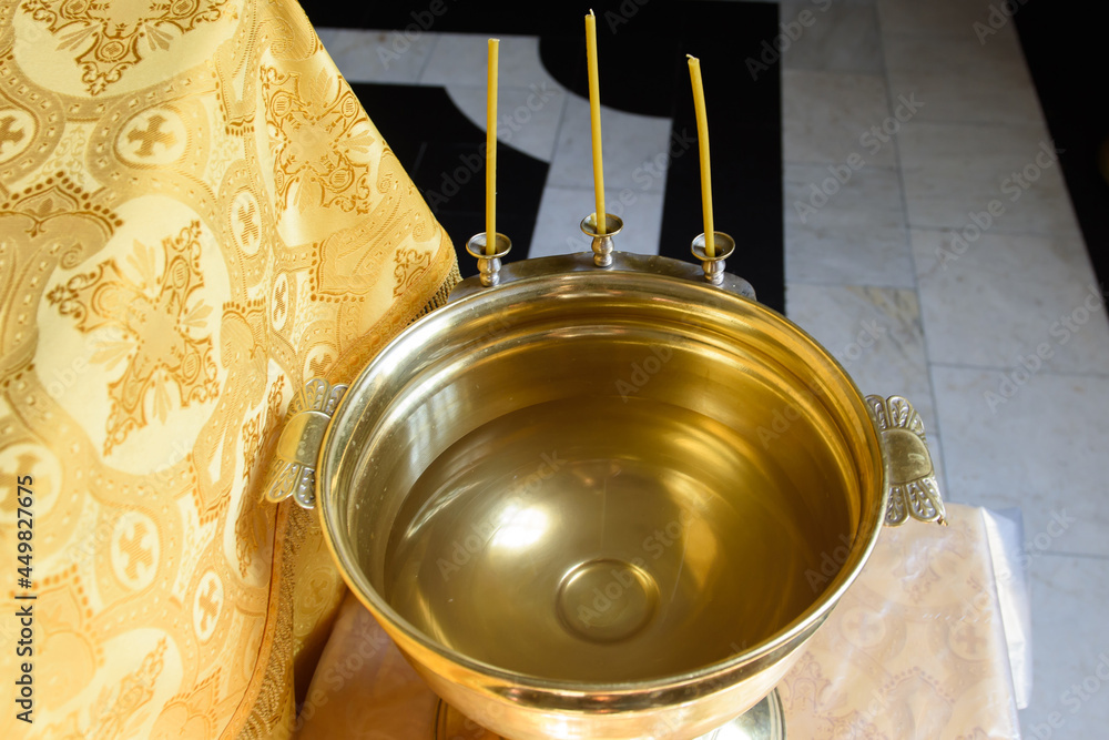 A font for the baptism of a child in a church. The ceremony of the Christian religion.