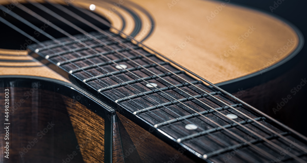 Close-up of a classical acoustic guitar in beautiful lighting. Close-up of a classical acoustic guitar in beautiful lighting.