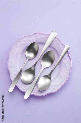 spoon in ceramic dish on pastel background