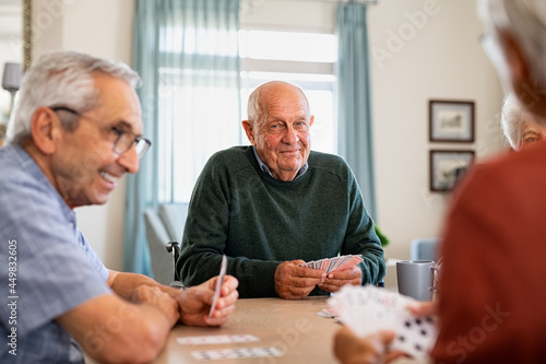 Принти на полотні Senior joyful friends playing cards together