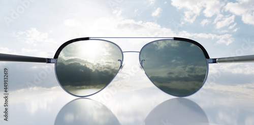 Polarized sunglasses on sunny sky UV protection