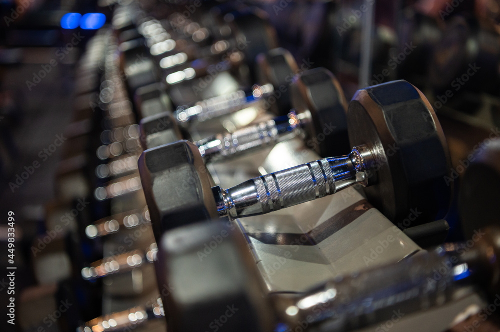 Rows of dumbbells on a rack in the fitness or gym. Rows of dumbbells on a rack in the fitness or gym.