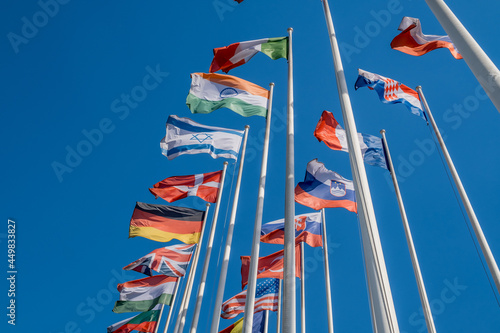 Different flags fluttering on flagpoles
