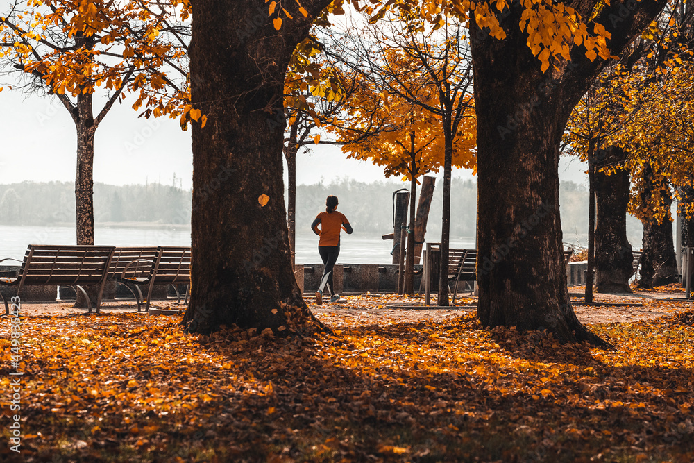 Woman running in the park, autumn landscape, lifestyle photo Woman running in the park, autumn landscape, lifestyle photo