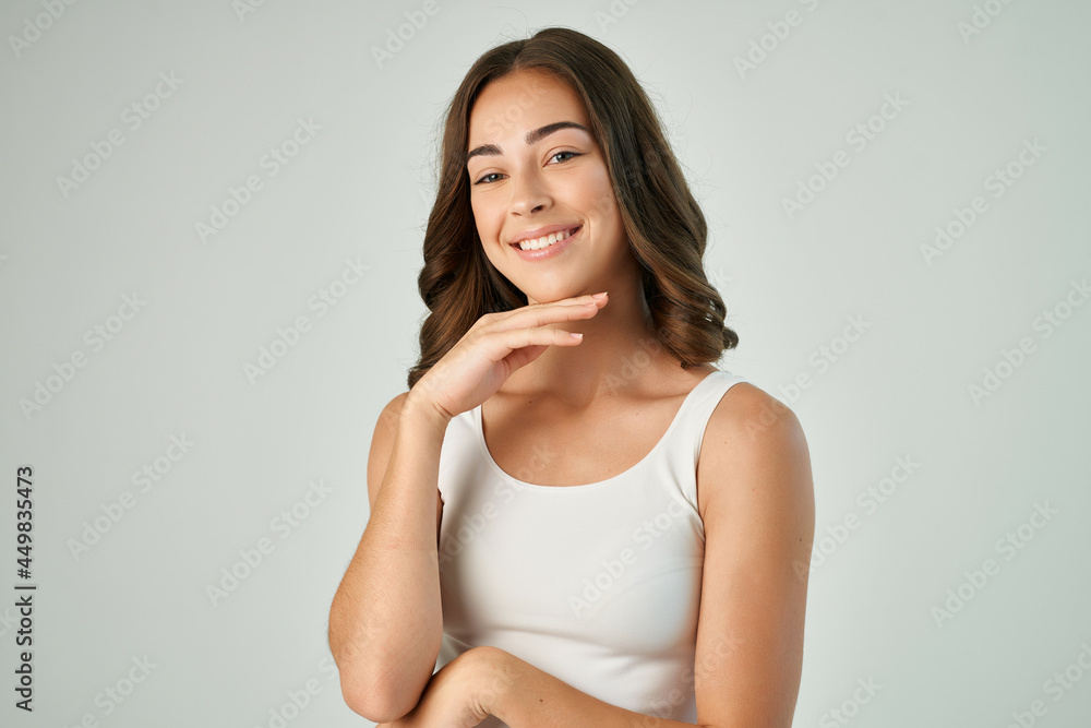 pretty brunette in white tank top holding hair fashion modern lifestyle pretty brunette in white tank top holding hair fashion modern lifestyle