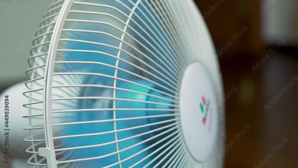 The Fan Operation Process. Rotation of the Fan Blades on a Hot Day, Close-up. The Fan Operation Process. Rotation of the Fan Blades on a Hot Day, Close-up.