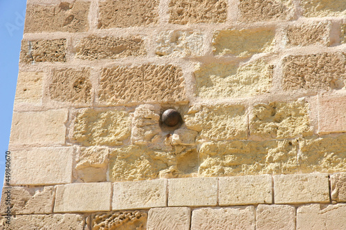 Bala de cañón empotrada en un muro del Castillo de Santa Bárbara en Alicante - Spain photo